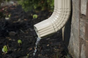 Clean your gutter, An exterior water pipe coming out of a commercial wall.
