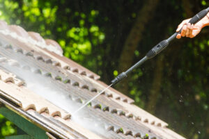 5 Factors to Consider When Choosing Roof Cleaners Near Me, pressure washer cleaning roof tiles